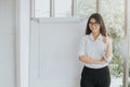 Confident Asian woman with blank flipchart