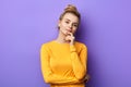 Confident atractive girl in yellow sweater looking at the camera Royalty Free Stock Photo