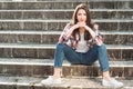 Confident attractive girl standing outside on stone stairs