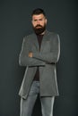 Confident and attractive. Confident hipster on grey background. Bearded man keeping arms crossed. Confident look of