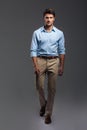 Confident attractive young manwalking and looking camera Royalty Free Stock Photo