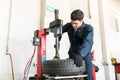 Auto Expert Using Tire Changer Machine At Repair Shop