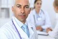 Confident bald doctor man with medical staff at the hospital Royalty Free Stock Photo