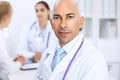 Confident bald doctor man with medical staff at the hospital Royalty Free Stock Photo