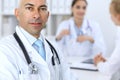 Confident bald doctor man with medical staff at the hospital Royalty Free Stock Photo