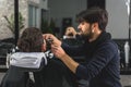 Confident barber serving customer at salon Royalty Free Stock Photo