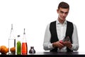 A barkeeper cleaning a capacity for cocktails, isolated on a white background. Barman behind a bar counter with a glass.