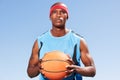 Confident, basketball player and outdoor portrait for sport, game and competition in summer with sky background. Serious Royalty Free Stock Photo