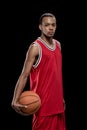 Confident basketball player standing with ball and looking at camera Royalty Free Stock Photo