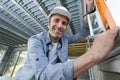 confident bearded builder man wearing hardhat using measurement-level