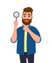 Confident bearded man holding magnifying glass and pointing hand finger towards. Search, find, discovery, analyze, inspect.