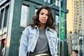 Beautiful young African woman looking at camera on city street, portrait. Royalty Free Stock Photo