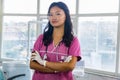 Confident Beautiful Indian Looking Nepali Dentist Doctor Girl Smiling and Giving gestures