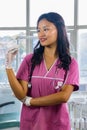 Confident Beautiful Indian Looking Nepali Dentist Doctor Girl Smiling and Giving gestures