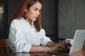 Confident beauty young Asian business woman working with laptop in workplace of office. Royalty Free Stock Photo