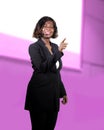 Confident black African American business woman with microphone speaking in auditorium at corporate seminar event giving success