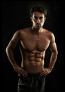 Confident, black background or portrait of man with six pack, strong abs or stomach in studio for fitness. Cool, model Royalty Free Stock Photo