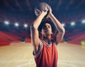 Young African American boy with basketball taking a free throw Royalty Free Stock Photo