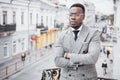 Confident black business man in a stylish suit standing on office block looking at the camera with a serious expression Royalty Free Stock Photo