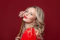 Confident blonde woman smiling on red background Royalty Free Stock Photo