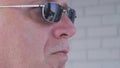 Confident Bodyguard Image Wearing Black Sunglasses Doing a Security Job