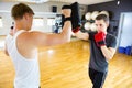 Confident Boxer Punching Bag Held By Instructor In Gym Royalty Free Stock Photo