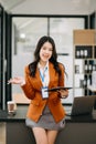 Confident business expert attractive smiling young asian woman holding digital tablet on desk in creative office Royalty Free Stock Photo
