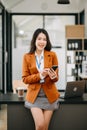 Confident business expert attractive smiling young asian woman holding digital tablet on desk in creative office Royalty Free Stock Photo