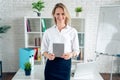 Confident business expert. Attractive young smiling woman in smart casual wear holding digital tablet and looking at camera while Royalty Free Stock Photo