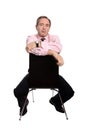 Confident business man sitting on a chair Royalty Free Stock Photo