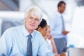 Confident business man smiling with executives. Portrait of confident senior business man smiling with executives in Royalty Free Stock Photo