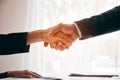 Confident business man and woman shaking hands during a meeting in the office