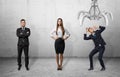 Confident business people standing straight and scared businessman shielding himself from the giant mechanical claw Royalty Free Stock Photo