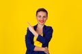 Confident business woman pointing at copy space background. Cheerful short hair smiling girl pointing with index finger away at Royalty Free Stock Photo