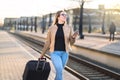 Confident business woman pulling suitcase. Royalty Free Stock Photo