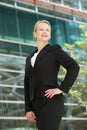 Confident business woman smiling outside office bu Royalty Free Stock Photo