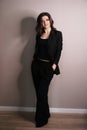 Confident business woman standing full length in black suit Royalty Free Stock Photo