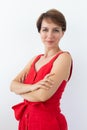 Confident business woman wearing red dress standing with crossed arms. Isolated portrait. Royalty Free Stock Photo