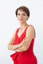 Confident business woman wearing red dress standing with crossed arms. Isolated portrait. Royalty Free Stock Photo