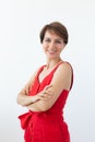 Confident business woman wearing red dress standing with crossed arms. Isolated portrait. Royalty Free Stock Photo