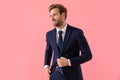 Confident businessman adjusting his jacket, looking away Royalty Free Stock Photo