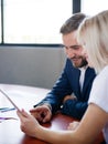 Handsome businessman and office woman working with tablet on a blurred background. Office meeting concept. Royalty Free Stock Photo