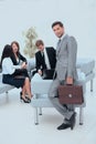 Confident businessman with briefcase standing in the lobby of the office. Royalty Free Stock Photo