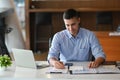 Businessman checking reports at his office desk. Royalty Free Stock Photo