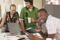 Confident Businessman With Colleagues Using Laptop Royalty Free Stock Photo