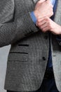 Confident businessman. Cropped shot of businessman in stylish suit straightens the sleeve