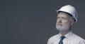 Confident businessman and engineer posing with a safety helmet Royalty Free Stock Photo