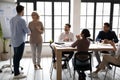 Executive shaking middle aged businesswoman hand at corporate meeting