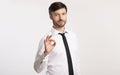 Confident Businessman Gesturing Okay Standing Over White Studio Background Royalty Free Stock Photo
