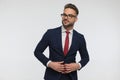 Confident businessman with glasses looking away and buttoning suit Royalty Free Stock Photo